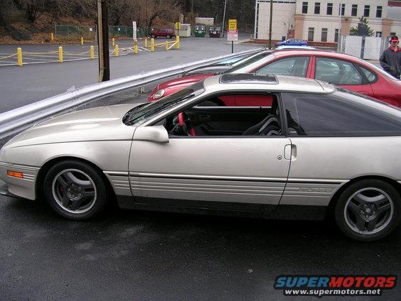 Silver 1989 Ford Probe coupe, side view, red interior
