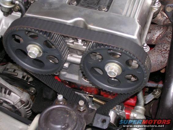 Engine timing belt and pulleys with visible SuperMotors.net watermark