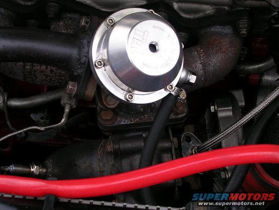 Silver turbocharger wastegate with TIAL logo, connected to engine components