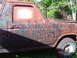 1982 Ford Bronco - Camouflaged Ford Bronco from the side, with visible door handle and fender detail.