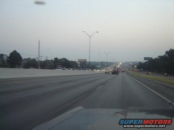 Highway traffic scene with cars and trucks on a multi-lane road