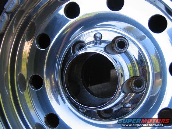 close-up of a shiny chrome wheel with multiple lug nut holes
