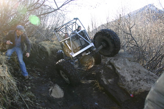 Off-road buggy with roll cage tilted on rocks