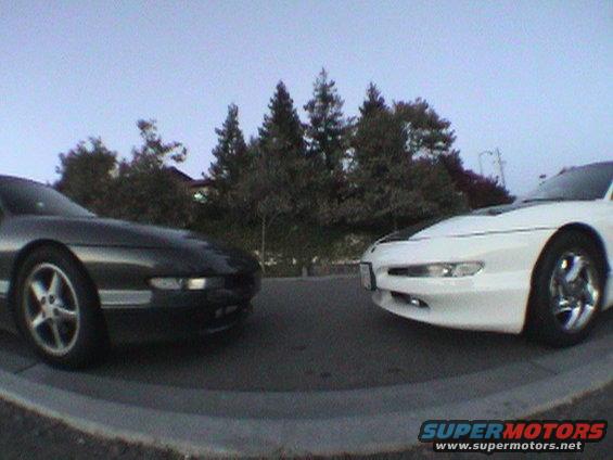 Two Ford Probes, one black and one white, facing each other