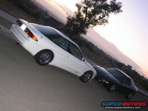 White 1997 Ford Probe GT parked with a black coupe behind it