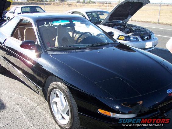 Black 1993 Ford Probe coupe with racing number 48 on windshield, parked on asphalt