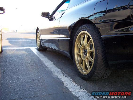 Black 1993 Ford Probe side view with gold rims