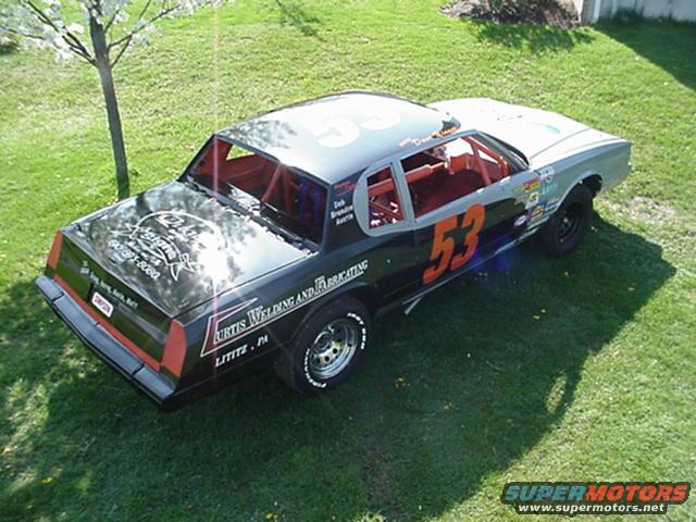 Stock car #53 with racing decals and sponsors on grass