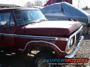 Red pickup truck front quarter view. Boat in background