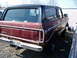 1979 Ford Bronco - Rear view of a maroon Ford Bronco with a black top, parked outdoors.