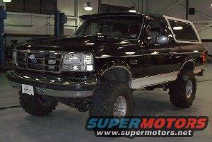 Black Ford Bronco with lifted suspension and large tires, seen from a 3/4 front angle
