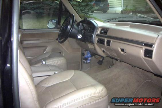 1993 Ford Bronco interior showing tan leather seats, dashboard, and steering wheel
