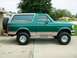 1996 Ford Bronco - This green Ford Bronco is shown from the side with a spare tire on the back.