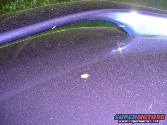 trunk lid, mark in center ..again was there since the purchase and has not changed at all... mark on the spoiler was most likely someone who can not properly use a detailing buffer... 