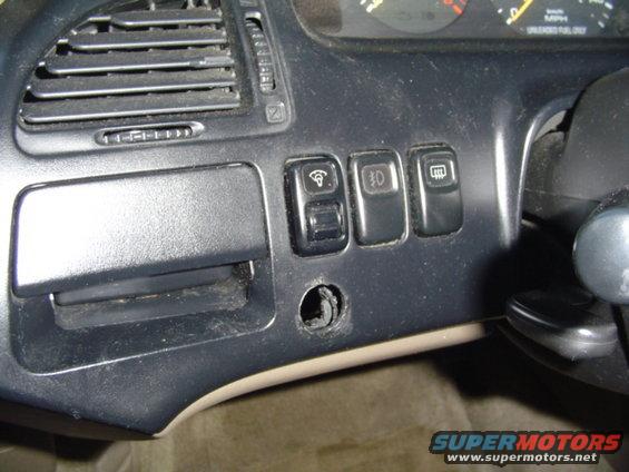 hole in dash from previous owner.. most likely for fog lights...