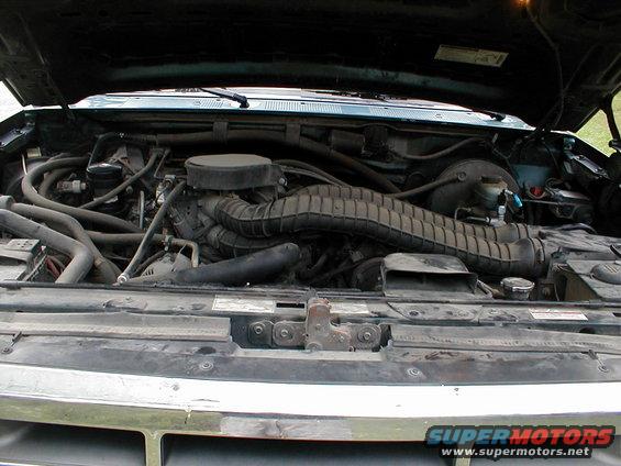 1994 Ford Bronco engine bay with hood open, showing the engine and air intake system