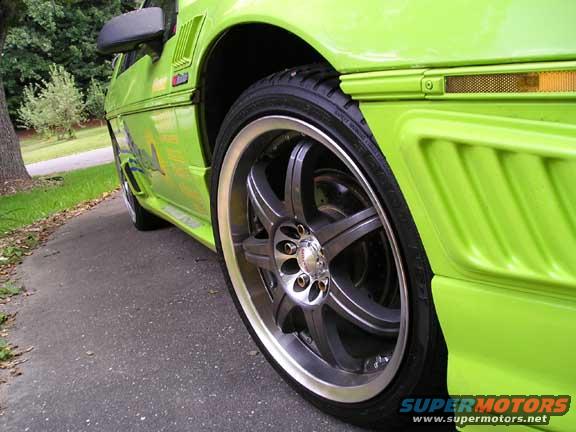Lime green 1984 Pontiac Fiero side view with custom wheels and body kit