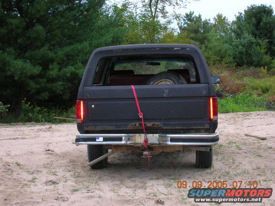 Black SUV rear view with spare tire inside