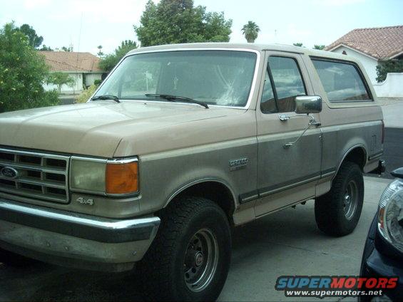 1988 Ford Bronco, two-tone tan and grey, parked in driveway