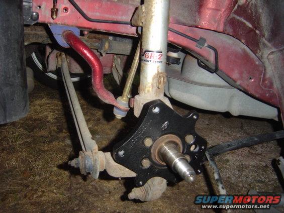 Red car's front suspension assembly with a red sway bar and GR-2 strut