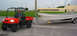 2005 Kubota RTV900 - An orange Kubota RTV is shown towing a boat on a trailer.