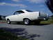 1966 Ford Fairlane - A white 1966 Ford Fairlane coupe is seen from the rear three-quarter angle on a sunny day.
