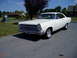 1966 Ford Fairlane - White 1966 Ford Fairlane coupe with chrome wheels and trim, seen from a 3/4 front angle.