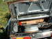 1978 Ford Mustang II - The trunk of a neglected vehicle, showing signs of rust and decay, contains a spare wheel.