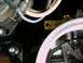 2002 Ford F-250 - A close-up view of various engine components, including wiring and a yellow lever, with "SUPERMOTORS" visible at the bottom.