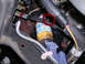 2002 Ford F-250 - Close-up view of engine components, including a fuel filter and a bottle of yellow fluid.