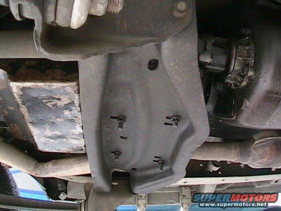 Looking from the drivers side.  To the left is the front, the right is the rear.  Immediately to the right of the cross member is where the transmission meets the transfer case.  The transfer case will have to be moved to the rear in order to detatch it from the transmission.