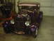 1978 Ford Bronco - A custom purple hot rod with a large engine is parked indoors.