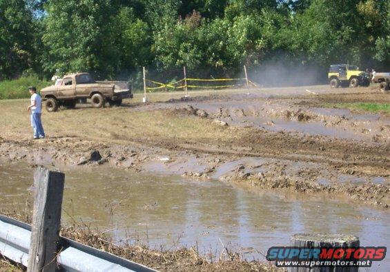 Muddy off-road course with a 1979 Ford F-150 and a yellow Jeep