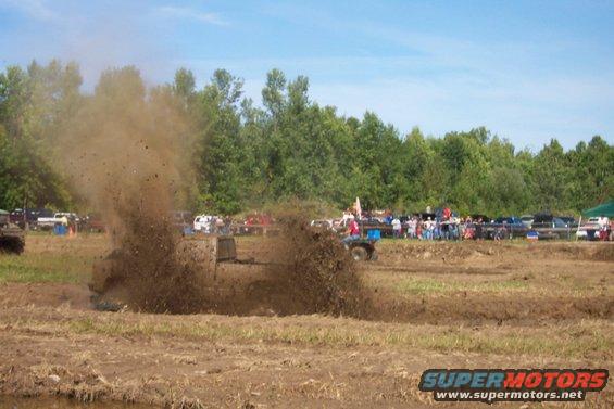 Truck spraying mud high in the air during a mud bog event