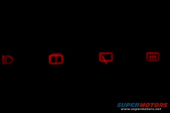 dashboard lights showing headlights, door ajar, and possibly a defroster icon
