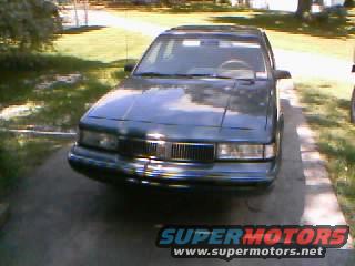 Dark green 1996 Oldsmobile Ciera sedan, front view, parked on driveway