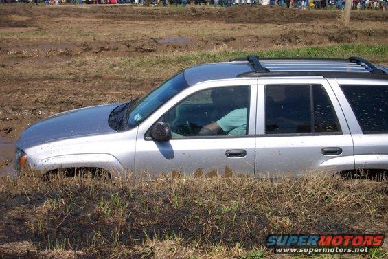 Silver SUV stuck in mud, side view