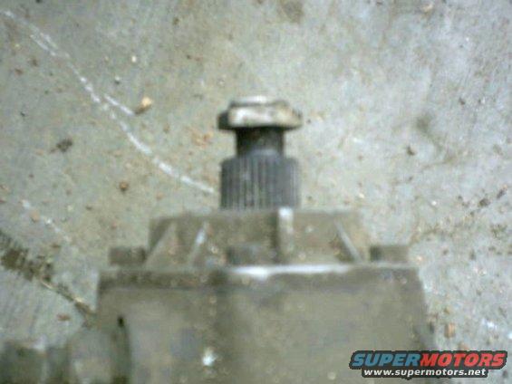 Close-up of a splined shaft protruding from a metal housing, likely a transmission part