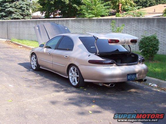 1998 Mercury Sable sedan, tan, hood and trunk open, parked on asphalt