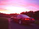 1993 Ford Thunderbird - A red coupe is captured from a rear quarter angle during a vibrant sunset.