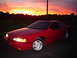 1993 Ford Thunderbird - Red 1993 Ford Thunderbird coupe parked during a vibrant sunset.