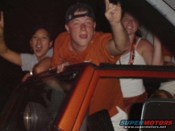 People celebrating inside a car at night
