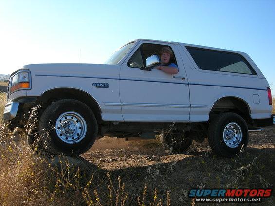 White 1994 Ford Bronco side view with driver