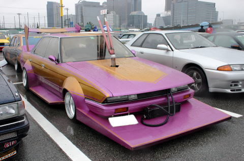 Customized purple and gold sedan with extreme body kit and large rear wing