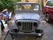1973 Jeep CJ5 - A gray Jeep CJ5 with a primer finish is parked outdoors next to another vehicle.