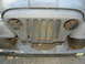 1973 Jeep CJ5 - Front end of a 1973 Jeep CJ5 showing the iconic seven-slot grille and fender area.