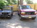 1973 Jeep CJ5 - Two trucks are parked in a driveway, one is a vintage Jeep and the other is a Ford F-Series.
