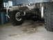 1979 Ford Bronco - The underside of an off-road vehicle shows its heavy-duty suspension and drivetrain components.