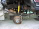 1983 Ford F-250 - The rear suspension and wheel assembly of a truck are shown, with leaf springs and a brake rotor prominent.