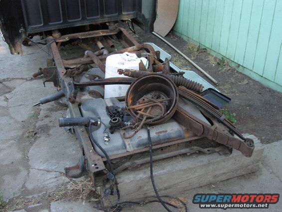 Truck chassis with fuel tank and suspension parts